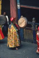 Monks: musician playing the drum, Paro Tshechu (tshe bcu).